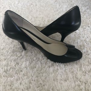 Black leather peep toe pumps